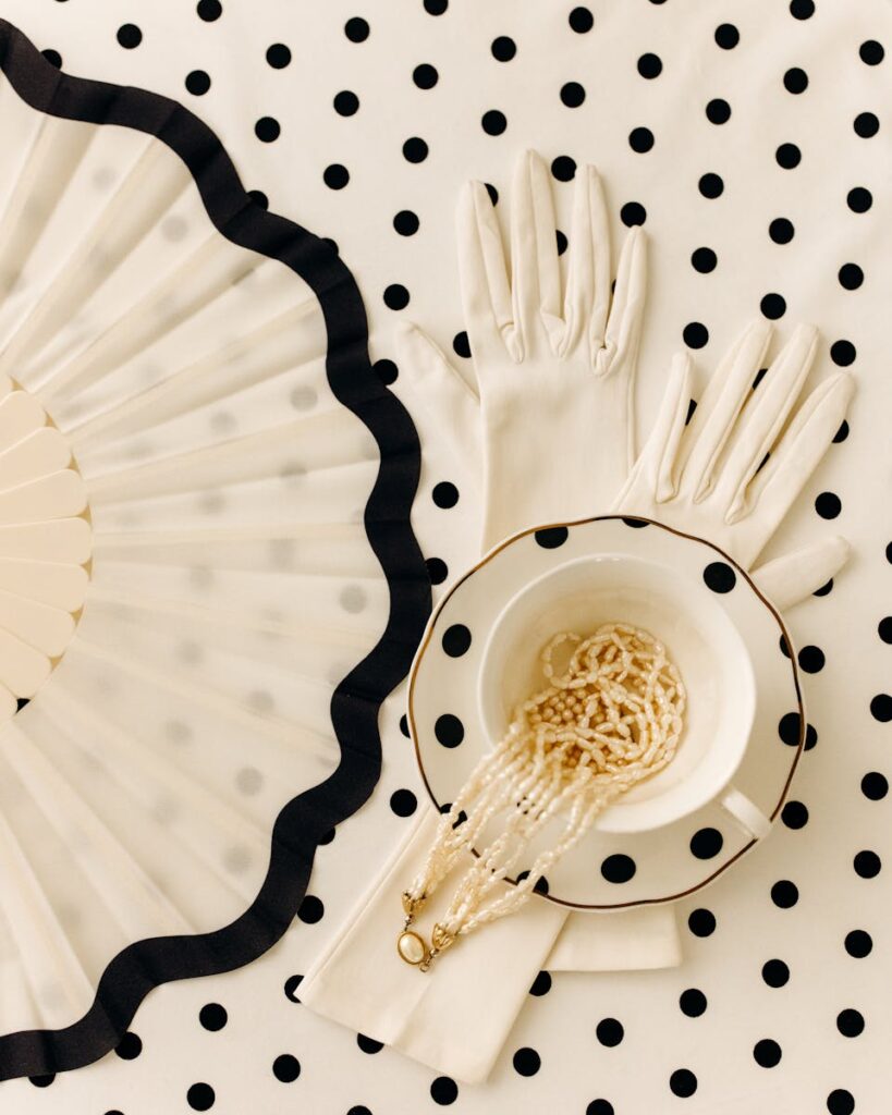 Sophisticated vintage accessories arranged on a polka dot background for an elegant display.